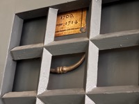 Town archive drawer behind locked grill